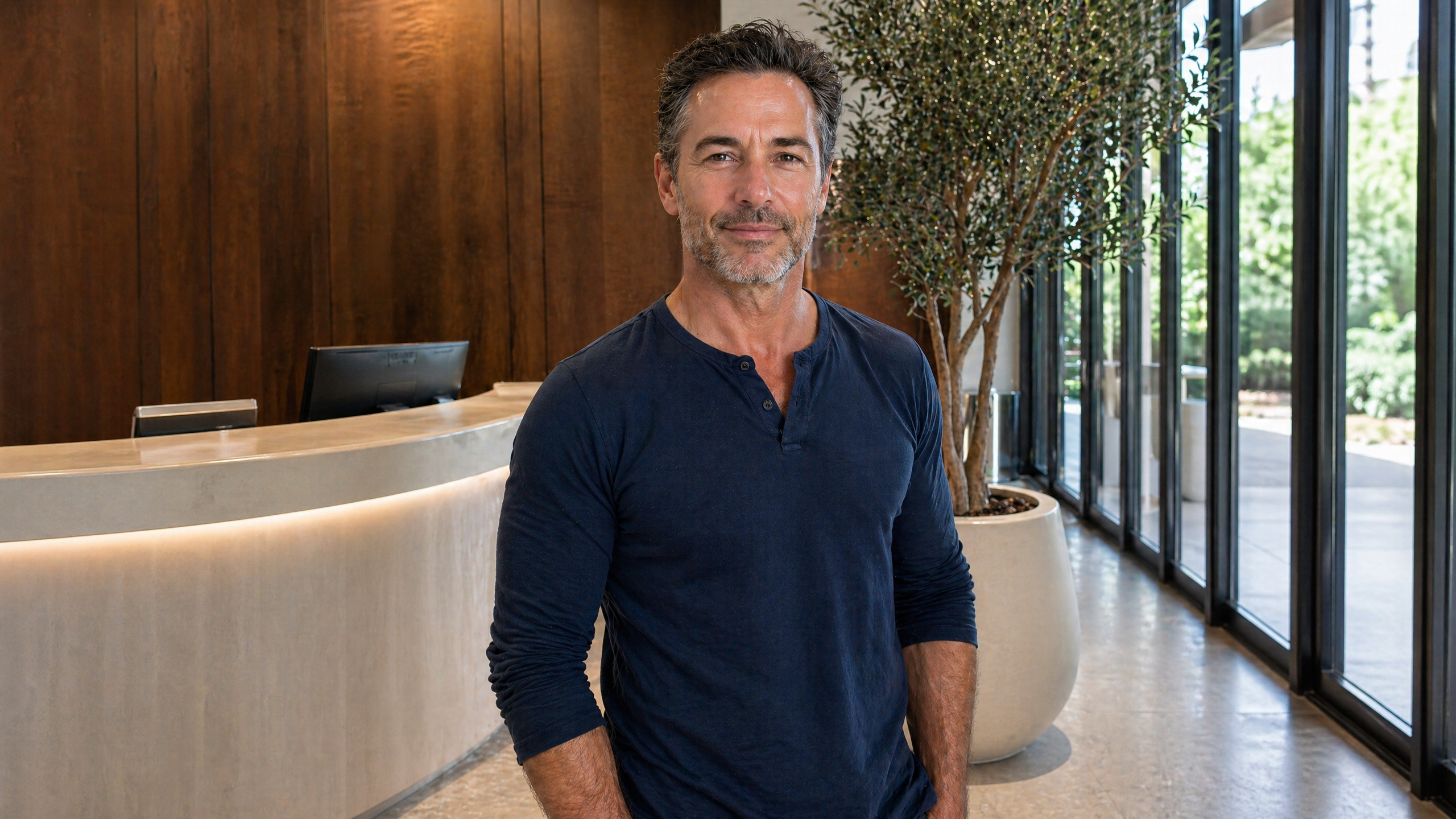 An Allure RT MX hair-restoration patient with a full, natural hairline in a clinic lobby