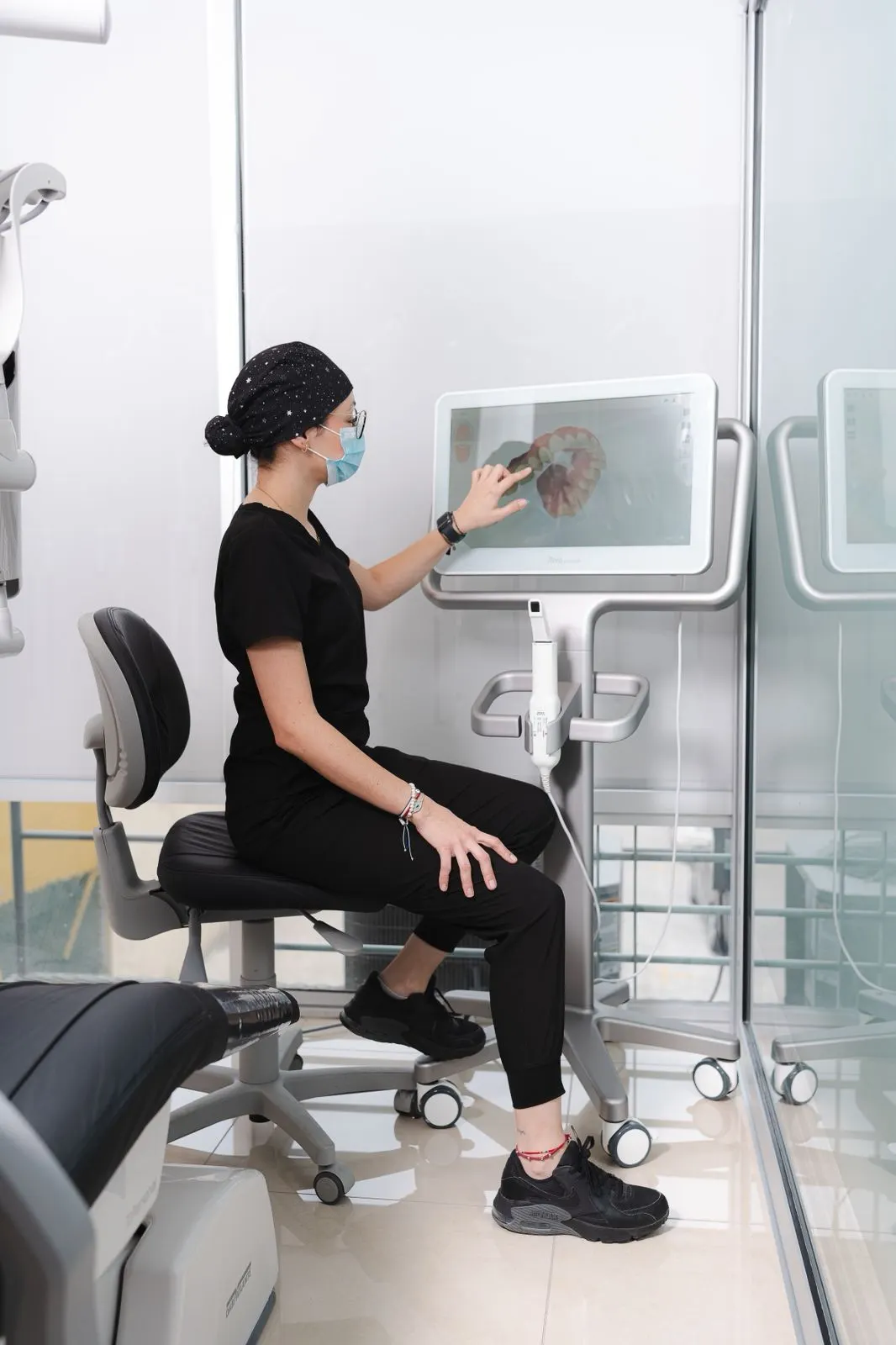 An Allure Dental team member reviewing a tooth diagram on a treatment-planning workstation