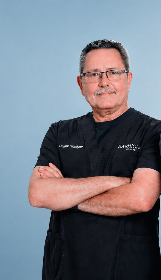 Dr. Leopoldo Sanmiguel, editorial portrait on a soft blue backdrop
