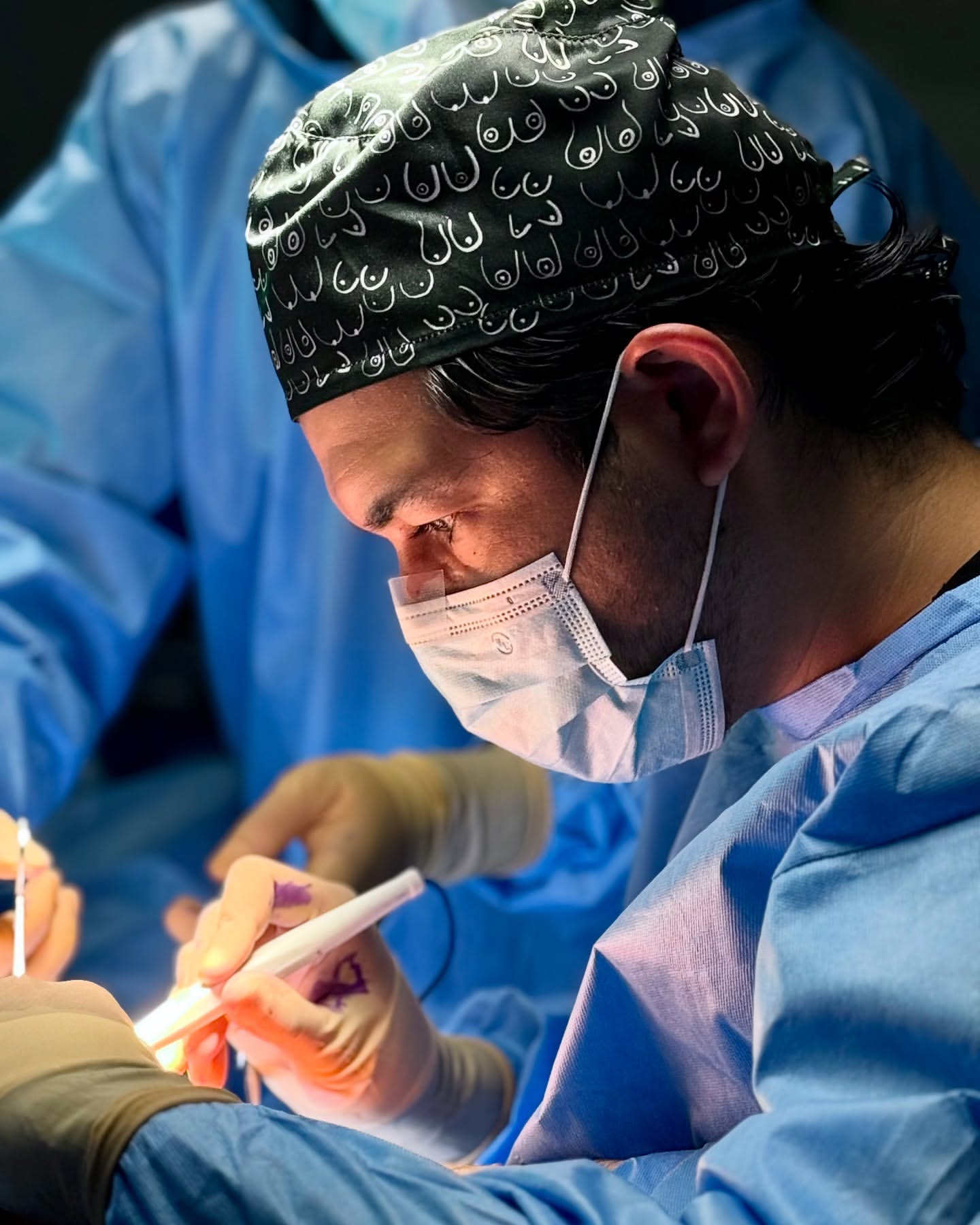 Dr. Otero drawing pre-operative skin markings on a draped patient