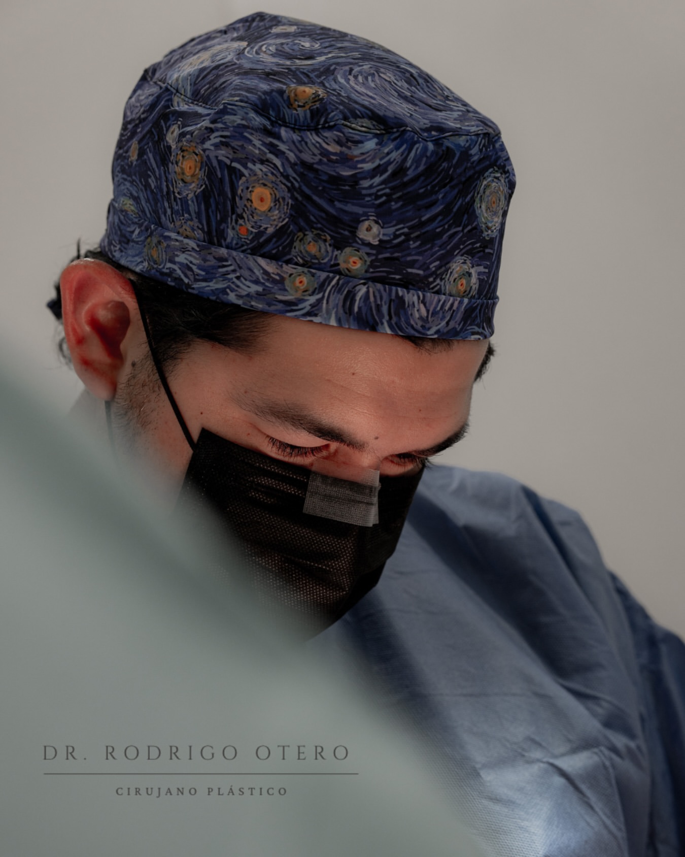 Dr. Otero focused mid-procedure wearing a Van Gogh-pattern surgical cap