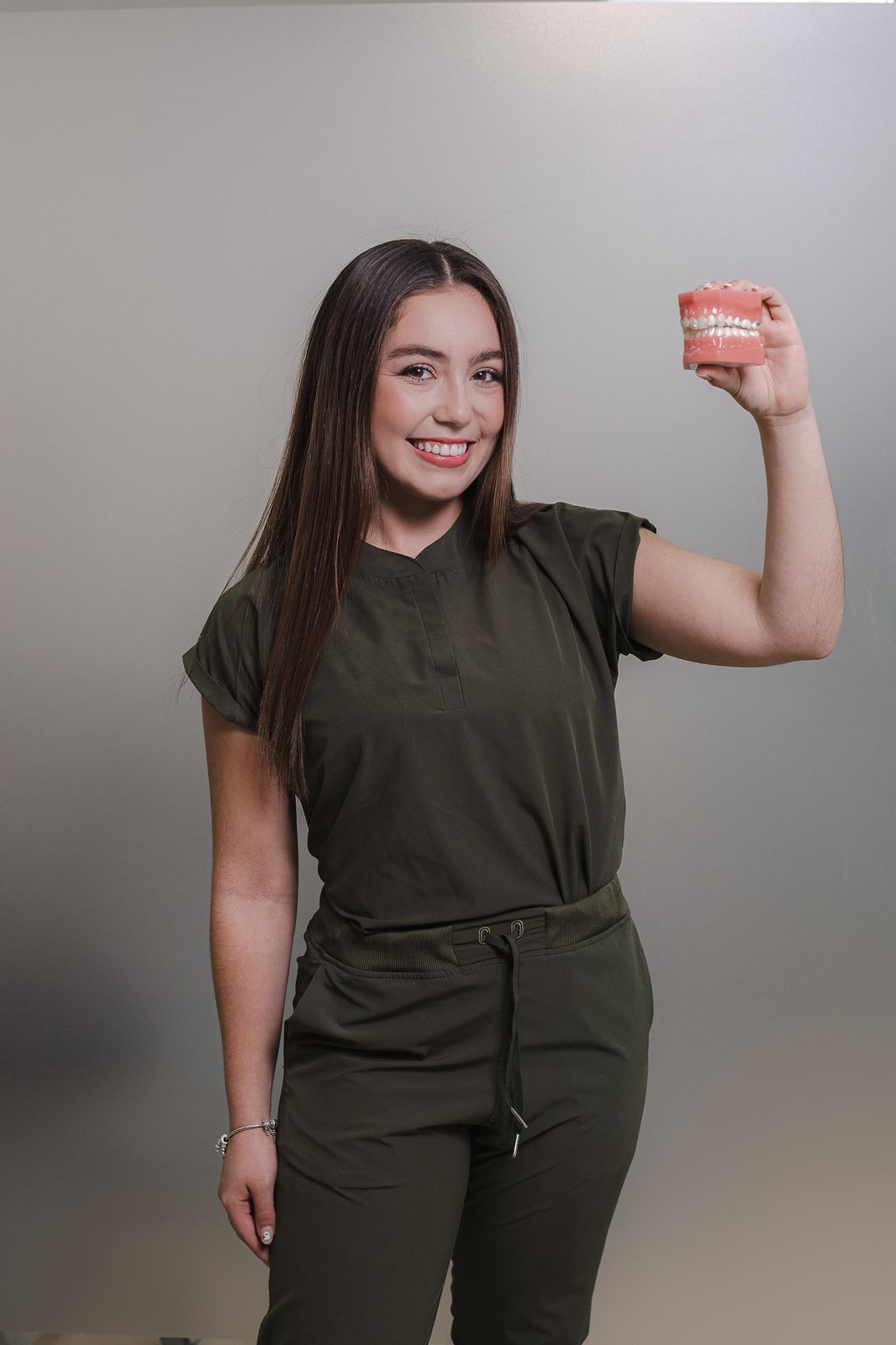 Dr. Rebecca Sanmiguel, lead dentist, holding a finished set of dentures