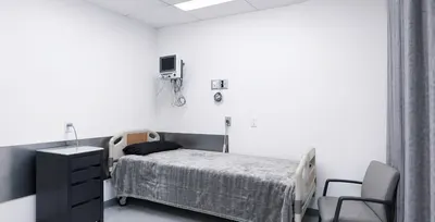 Private recovery room with hospital bed and monitor at the Tijuana clinic